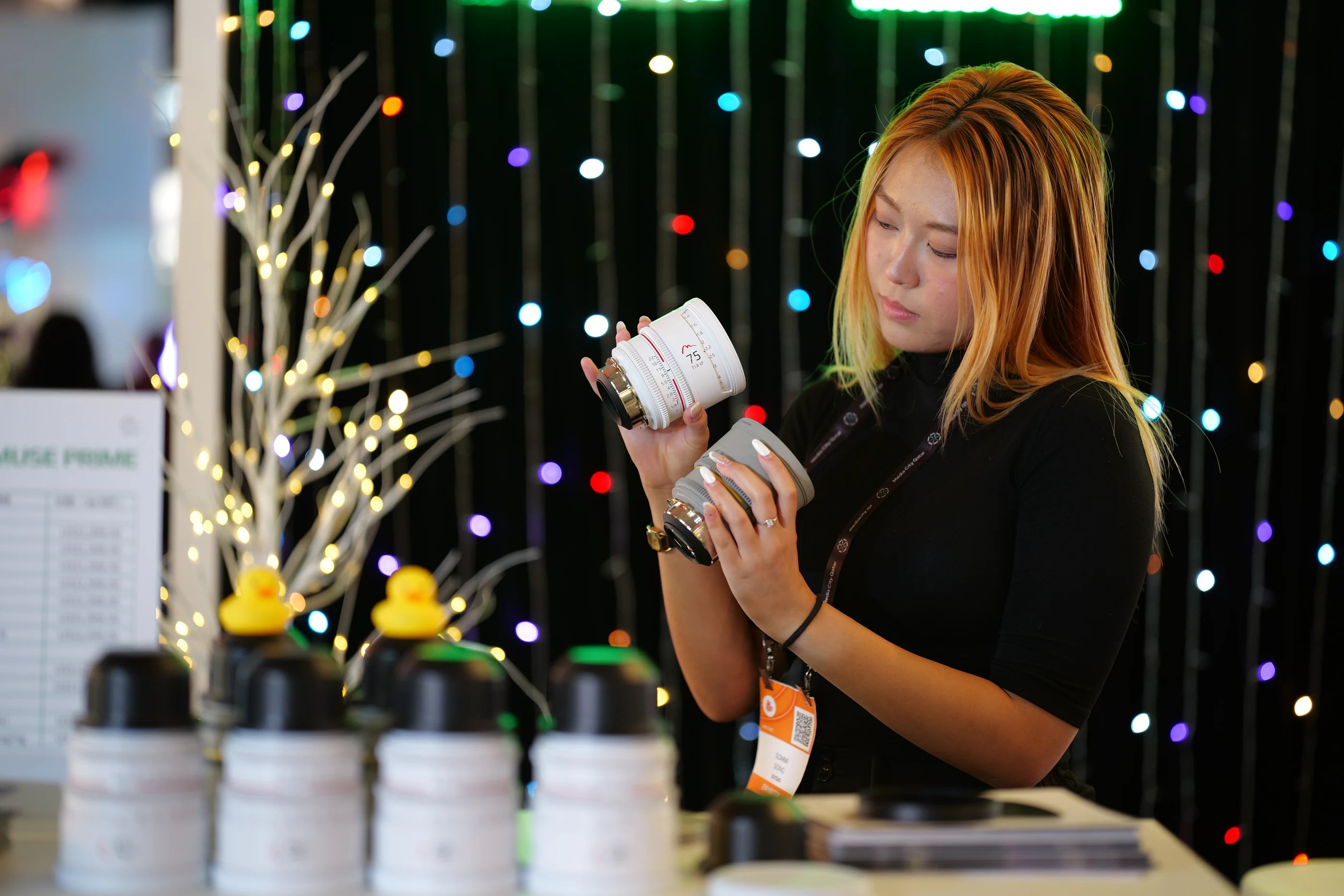 MUSE PRIME lens being handled at an industry event